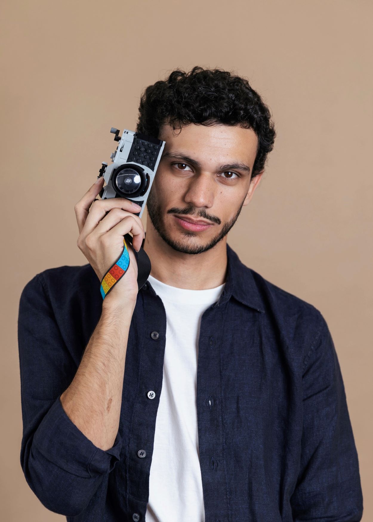 Bryan holding a lego camera stylistically